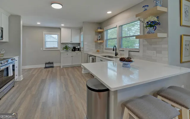 a kitchen with a sink appliances and a counter top space