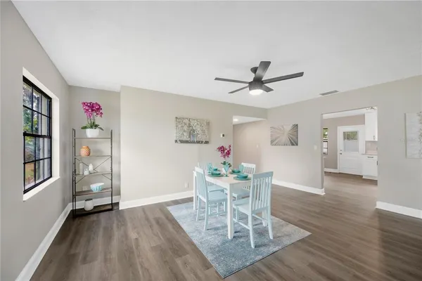 a view of a dining room with furniture and wooden floor