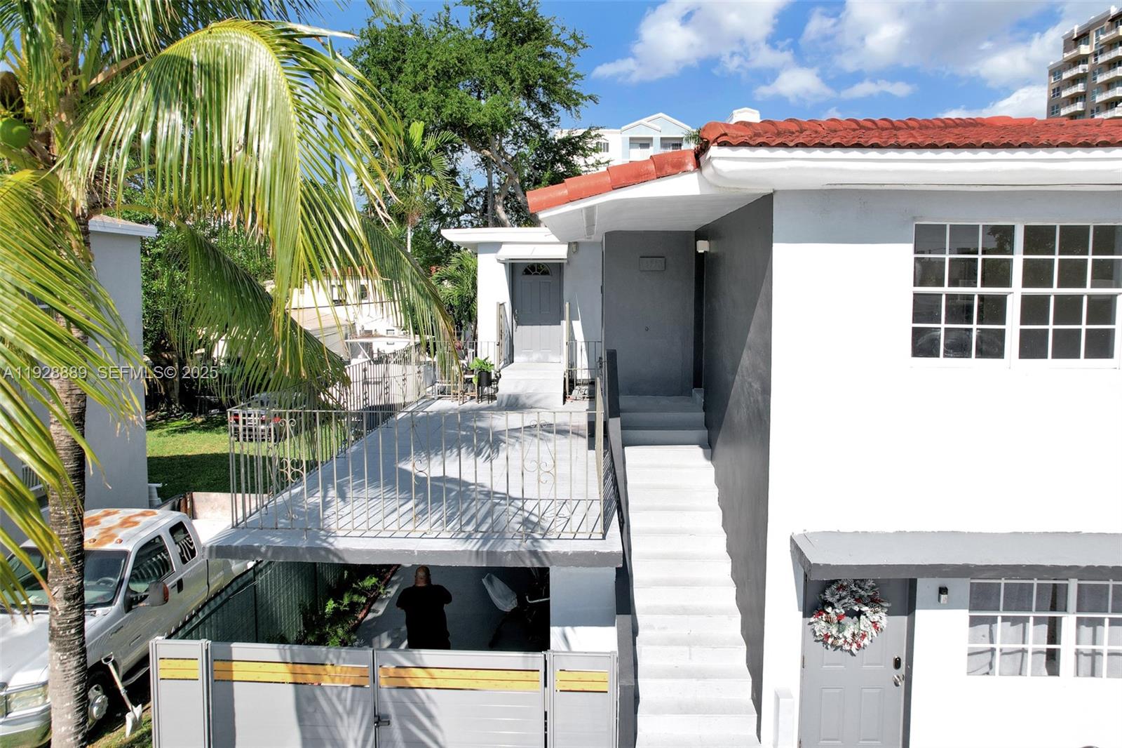 3711 Southwest 27th Terrace Miami, FL 33134 - Photo 12 of 62 a view of a patio with table and chairs with wooden floor and fence