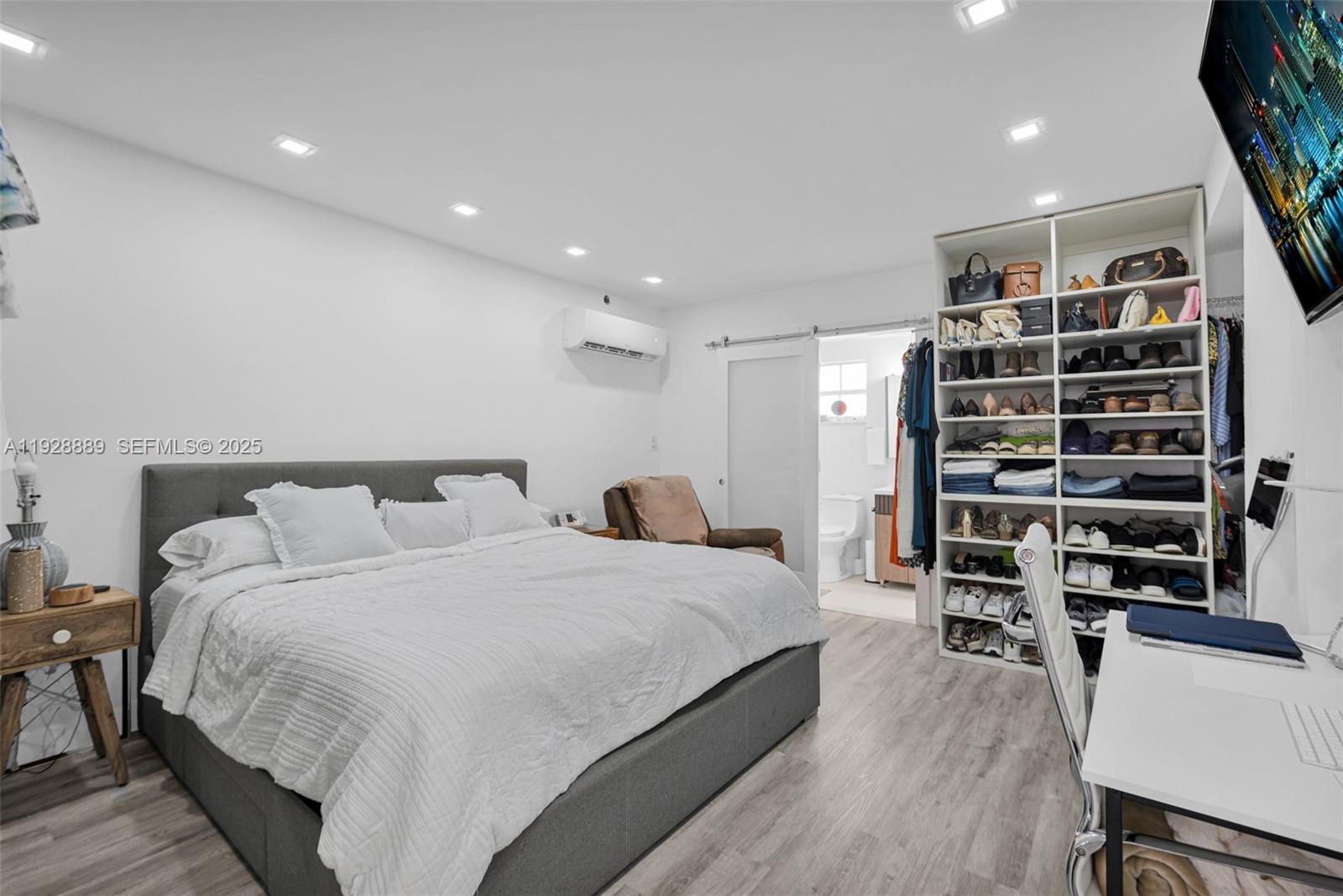 3711 Southwest 27th Terrace Miami, FL 33134 - Photo 17 of 62 a large bedroom with a bed and a book shelf