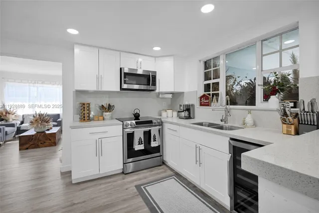 a bedroom with two beds and a potted plant