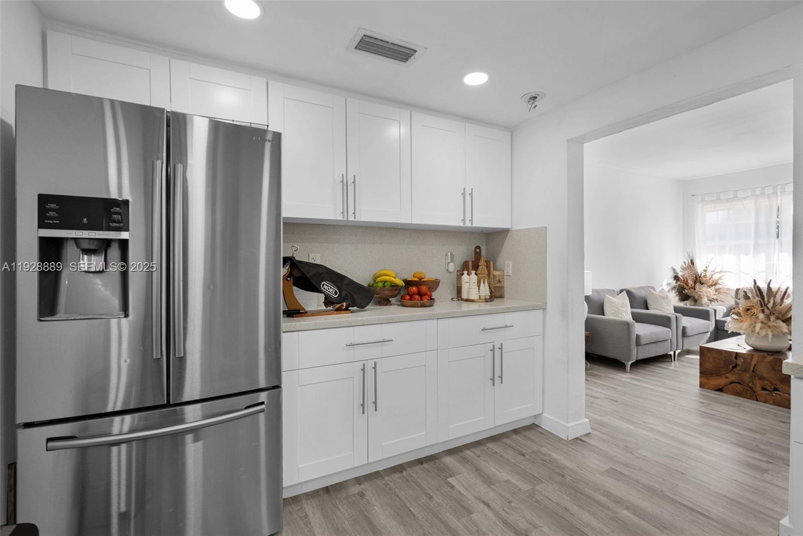 3711 Southwest 27th Terrace Miami, FL 33134 - Photo 22 of 62 a kitchen with stainless steel appliances granite countertop a refrigerator sink and cabinets