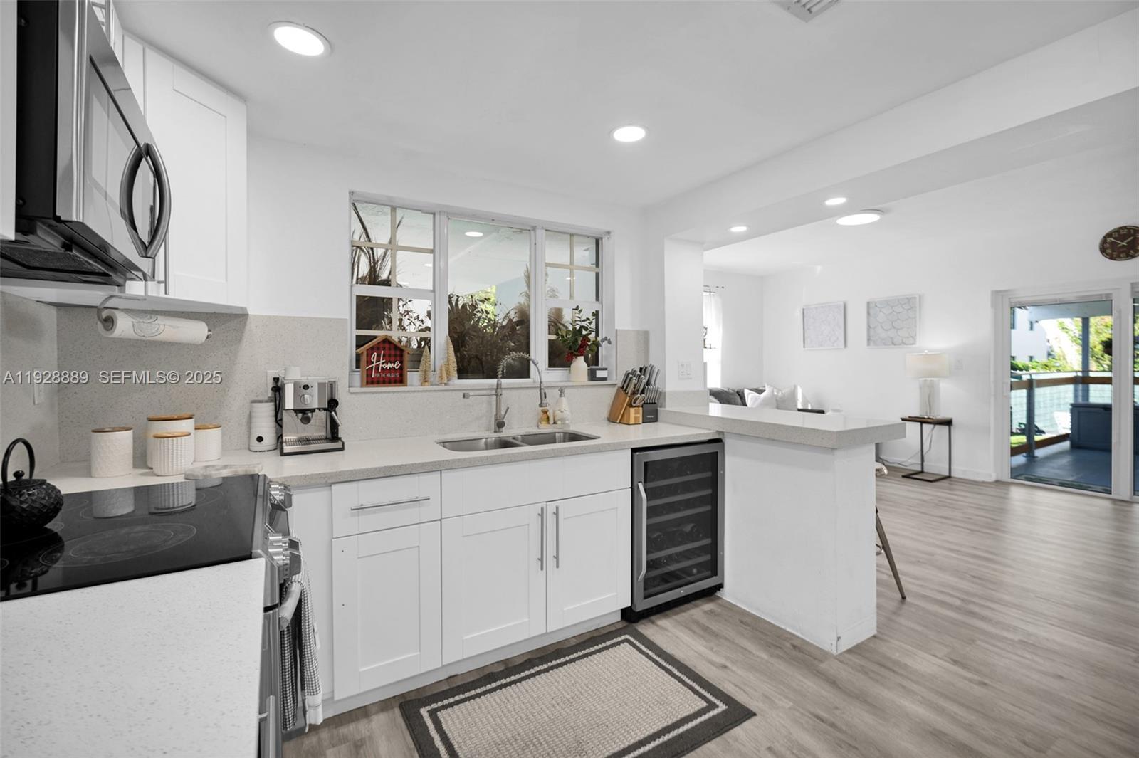 3711 Southwest 27th Terrace Miami, FL 33134 - Photo 24 of 62 a kitchen with sink a microwave and cabinets