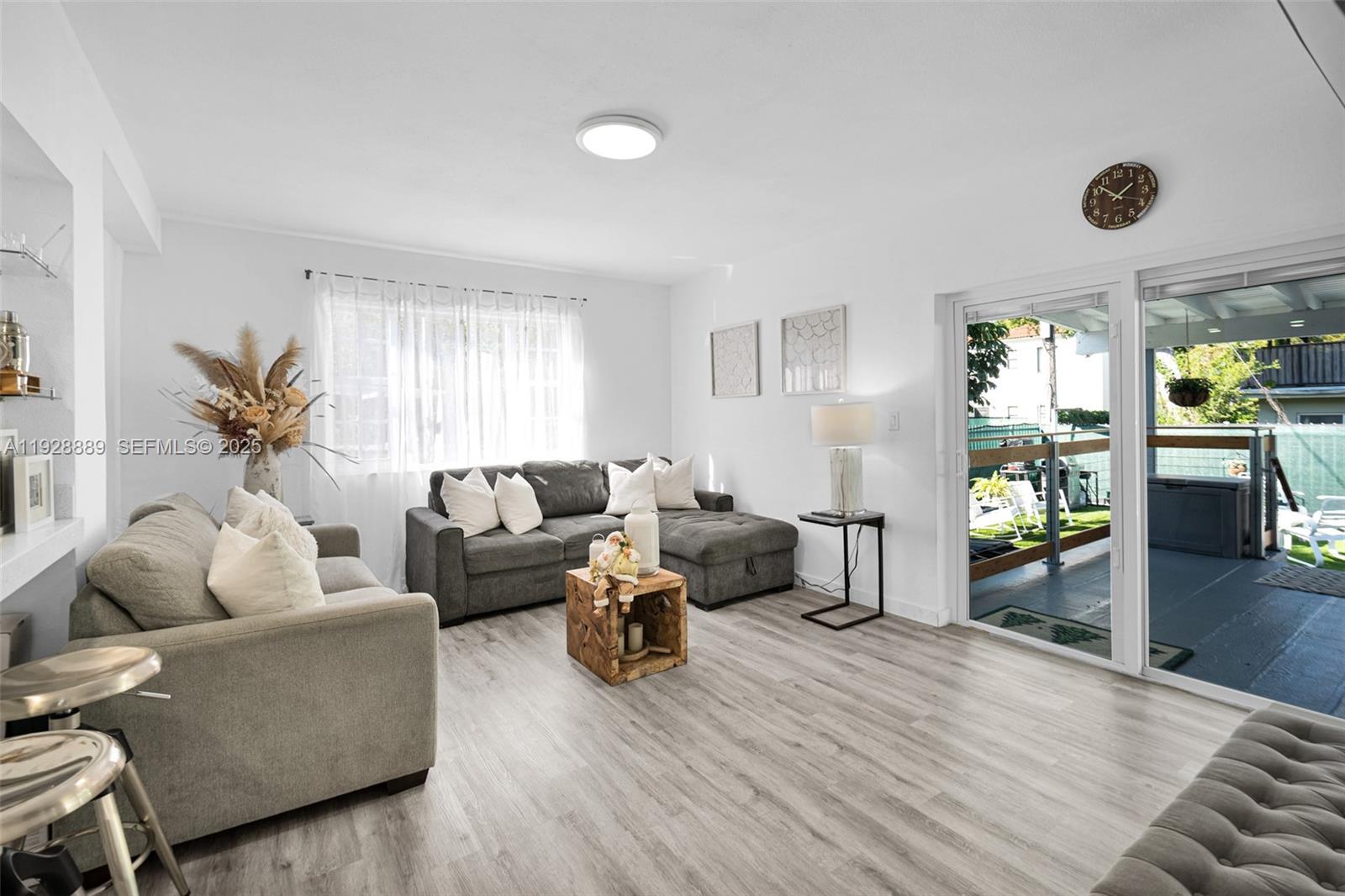 3711 Southwest 27th Terrace Miami, FL 33134 - Photo 30 of 62 a living room with furniture and a wooden floor