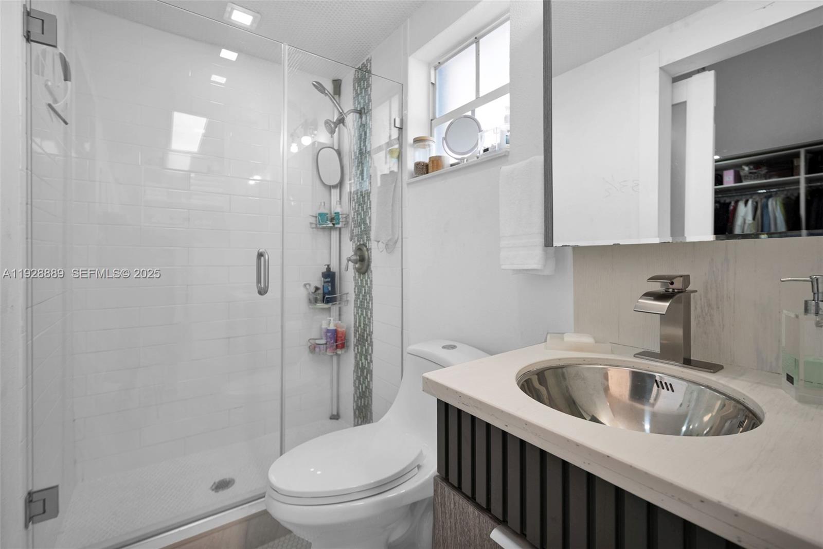 3711 Southwest 27th Terrace Miami, FL 33134 - Photo 35 of 62 a bathroom with a sink a toilet and shower