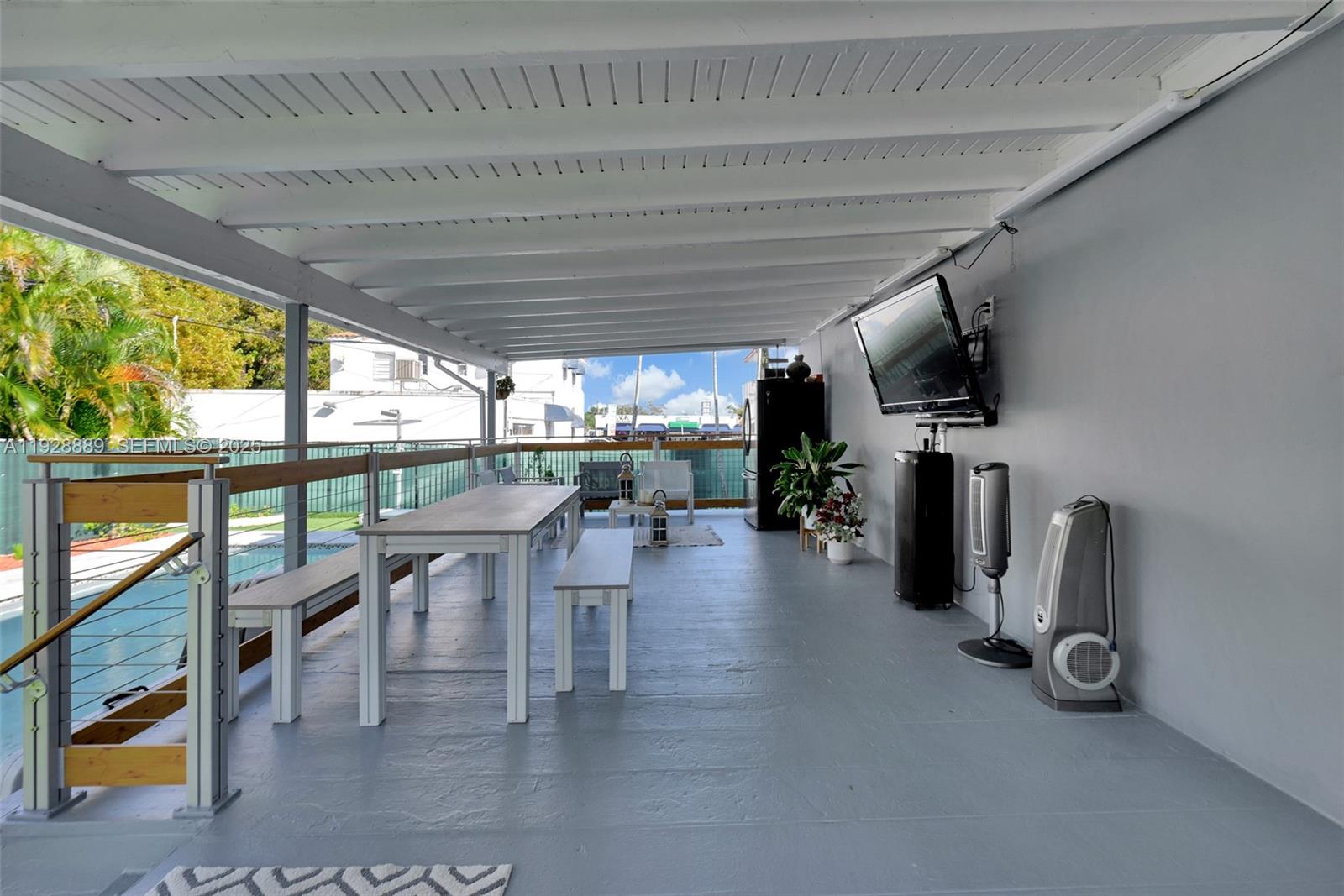 3711 Southwest 27th Terrace Miami, FL 33134 - Photo 36 of 62 a dining room with furniture water view and a floor to ceiling window