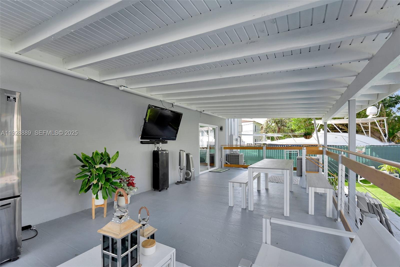 3711 Southwest 27th Terrace Miami, FL 33134 - Photo 39 of 62 a living room with furniture tv and a potted plant