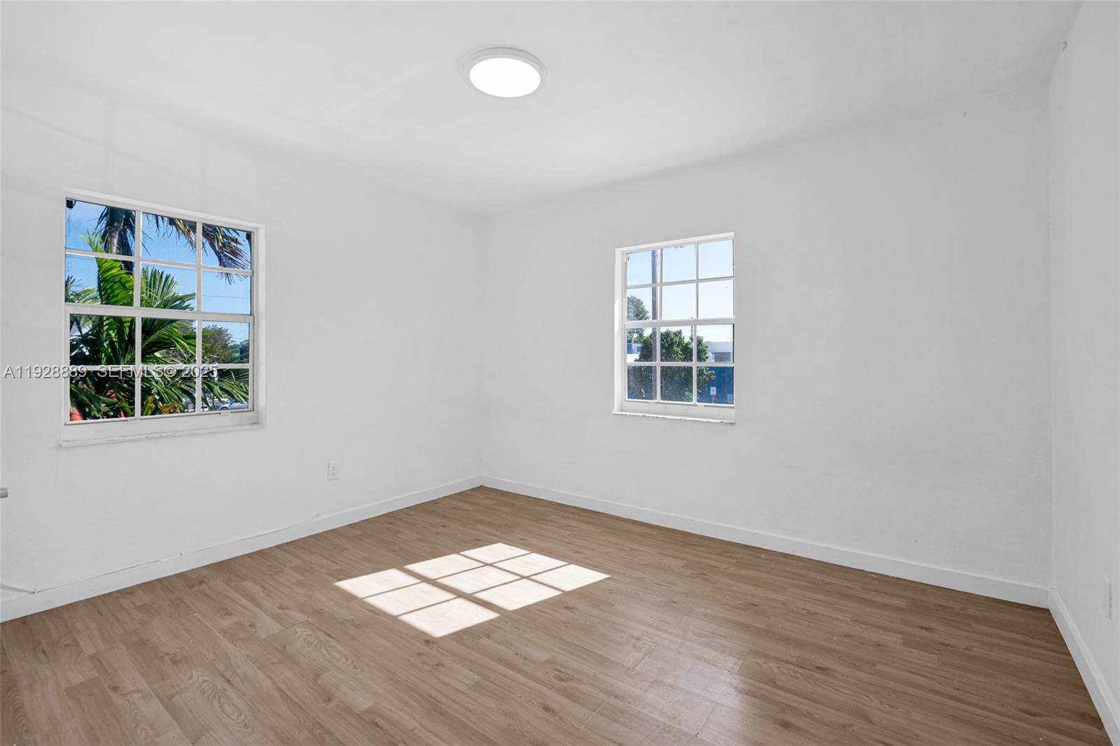 3711 Southwest 27th Terrace Miami, FL 33134 - Photo 49 of 62 an empty room with wooden floor and windows