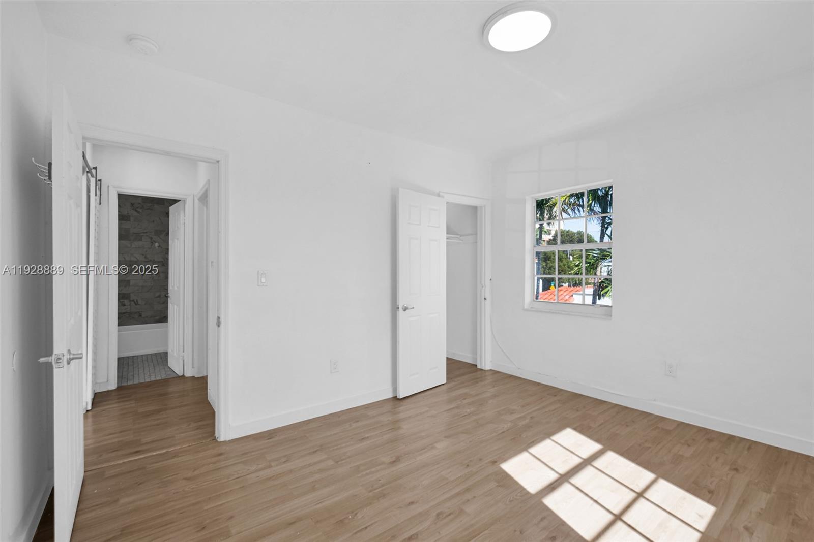 3711 Southwest 27th Terrace Miami, FL 33134 - Photo 50 of 62 an empty room with wooden floor and windows