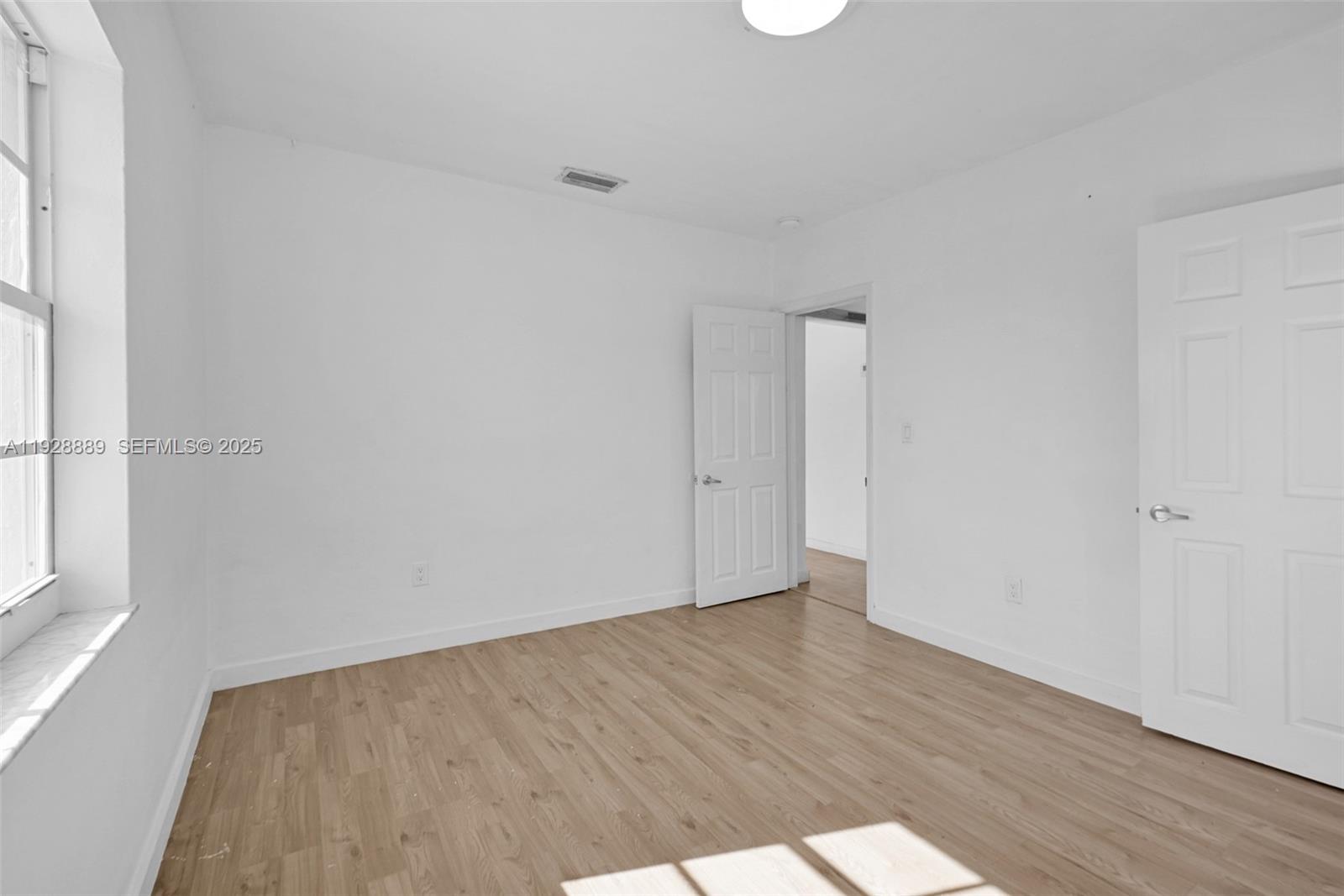 3711 Southwest 27th Terrace Miami, FL 33134 - Photo 51 of 62 an empty room with wooden floor and windows