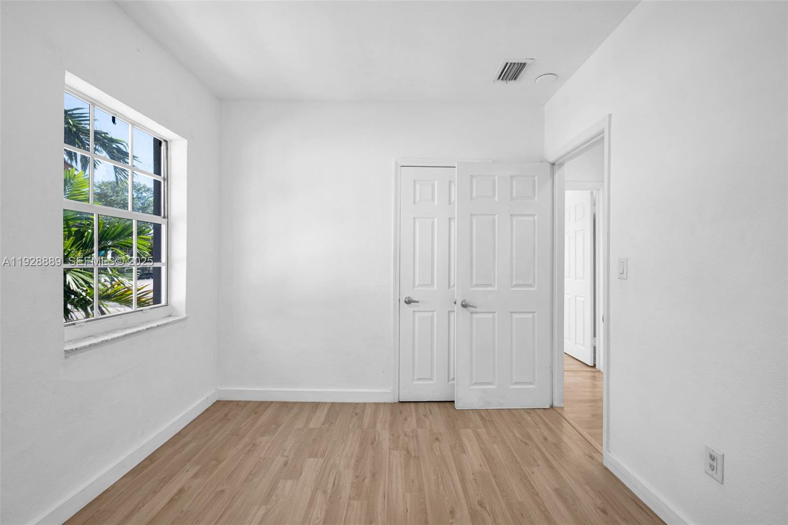 3711 Southwest 27th Terrace Miami, FL 33134 - Photo 52 of 62 a view of an empty room with wooden floor and a window