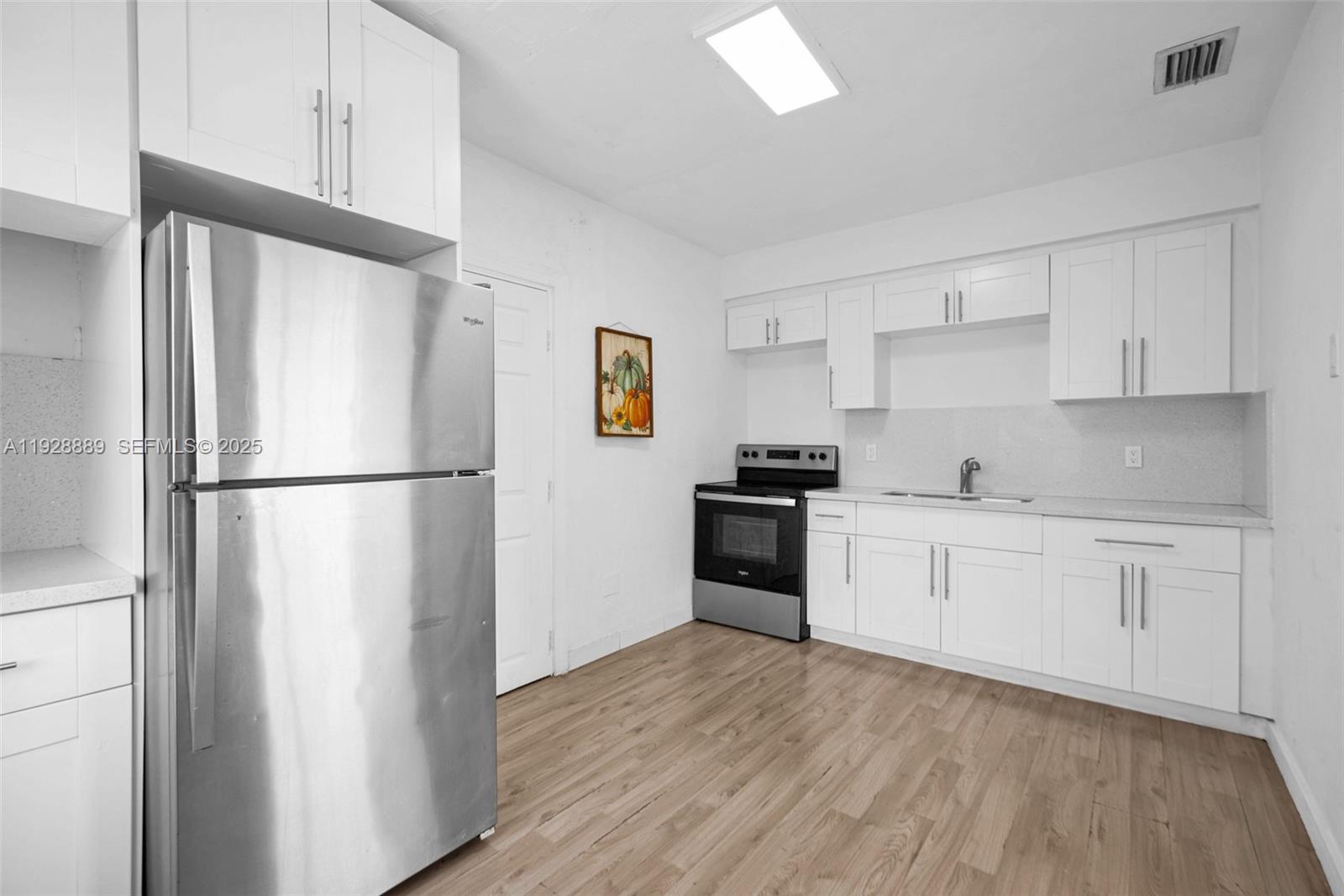 3711 Southwest 27th Terrace Miami, FL 33134 - Photo 54 of 62 a kitchen with granite countertop a refrigerator stove top oven and sink