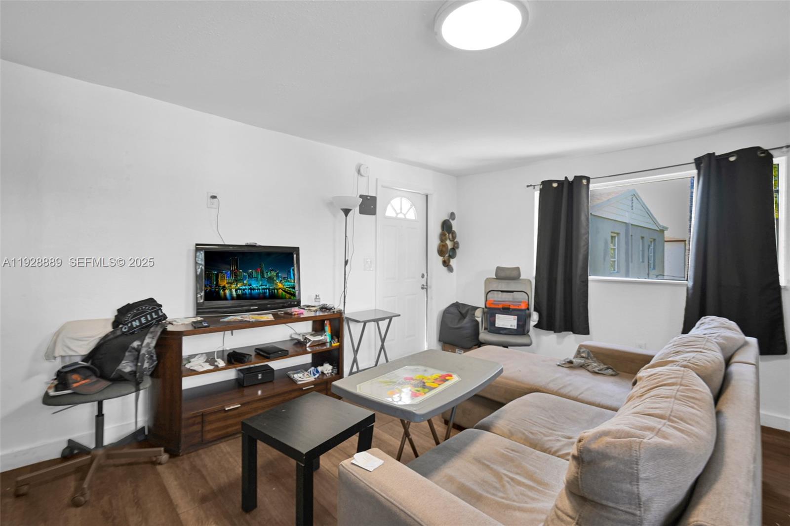 3711 Southwest 27th Terrace Miami, FL 33134 - Photo 56 of 62 a living room with furniture and a flat screen tv