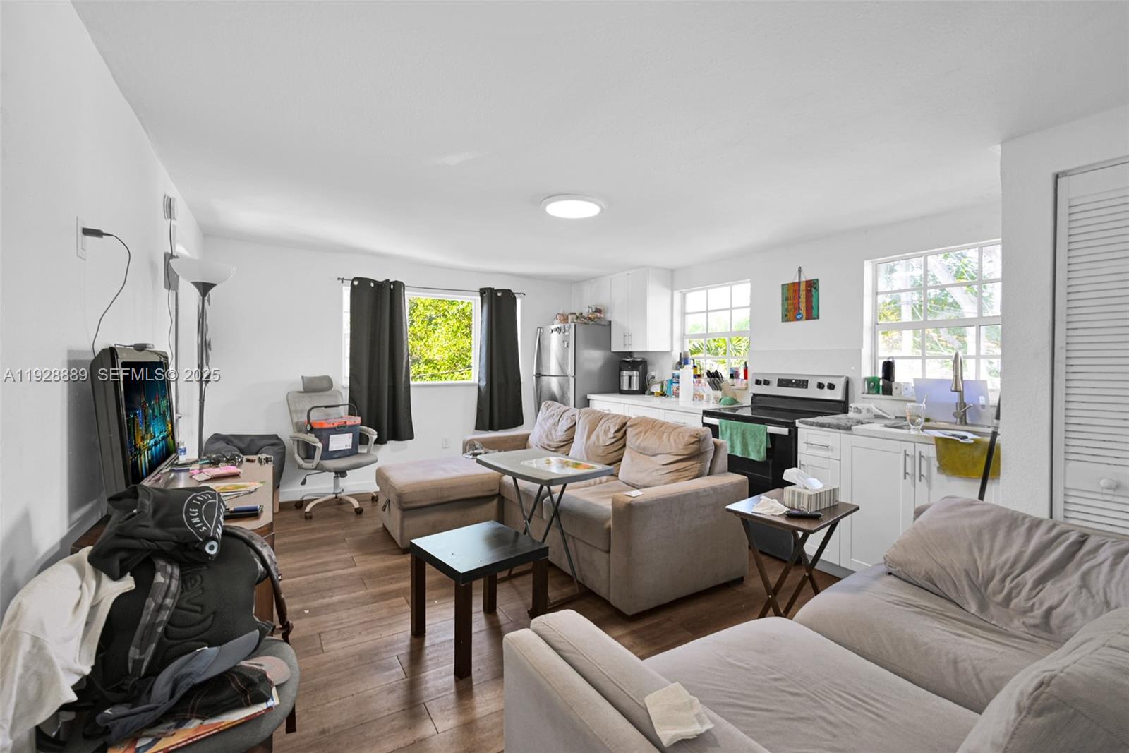 3711 Southwest 27th Terrace Miami, FL 33134 - Photo 57 of 62 a living room with furniture kitchen view and a window