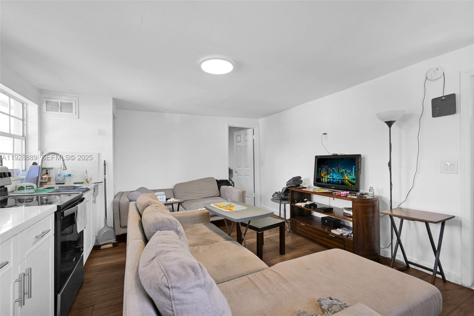 3711 Southwest 27th Terrace Miami, FL 33134 - Photo 58 of 62 a living room with furniture a flat screen tv and a table