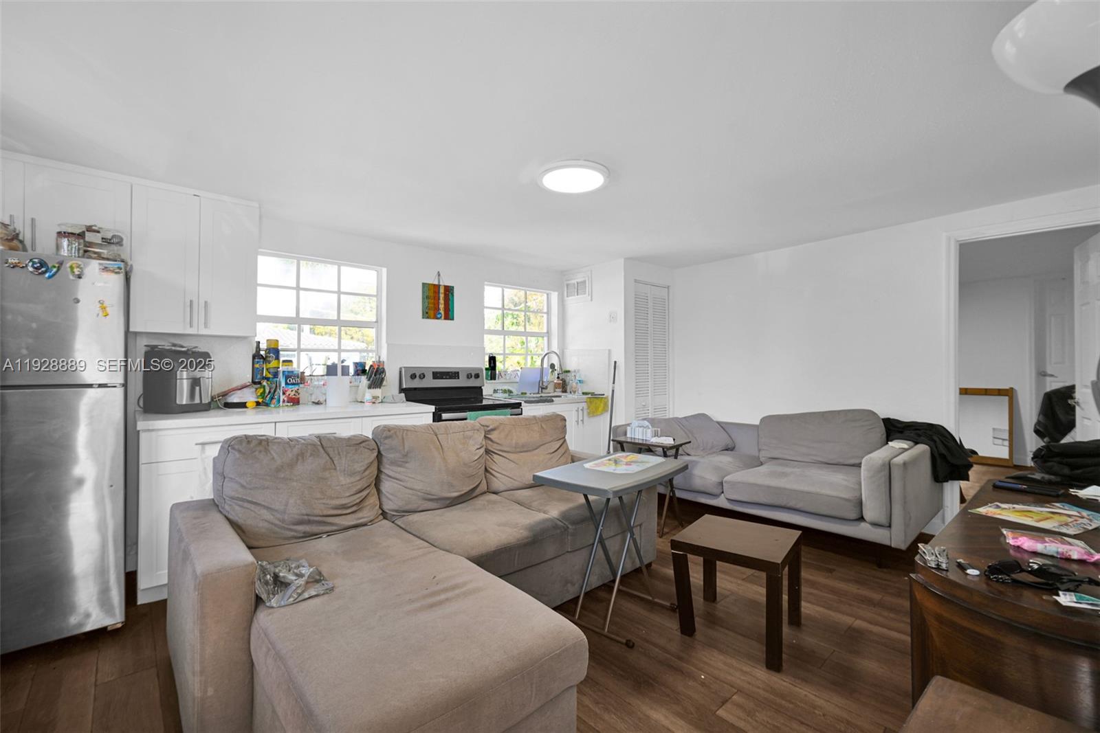 3711 Southwest 27th Terrace Miami, FL 33134 - Photo 59 of 62 a living room with furniture and a refrigerator