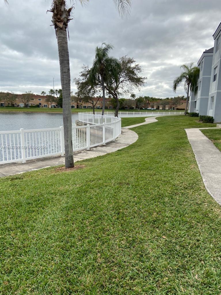 8640 Southwest 212th Street, Unit 304 Cutler Bay, FL 33189 - Photo 15 of 26 a view of a lake with a building in the background