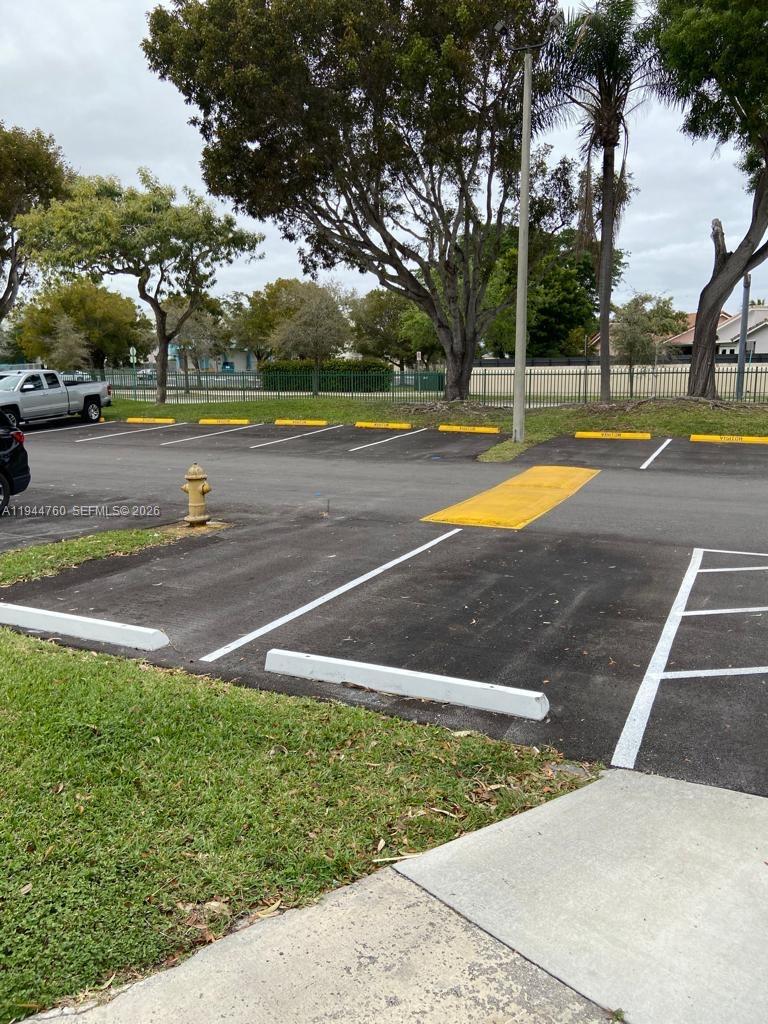 8640 Southwest 212th Street, Unit 304 Cutler Bay, FL 33189 - Photo 18 of 26 a view of a swimming pool with an outdoor space and seating area