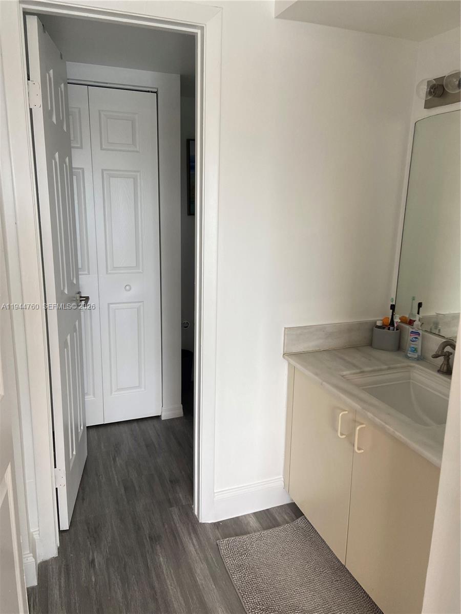 8640 Southwest 212th Street, Unit 304 Cutler Bay, FL 33189 - Photo 8 of 26 a bathroom with a sink and a mirror