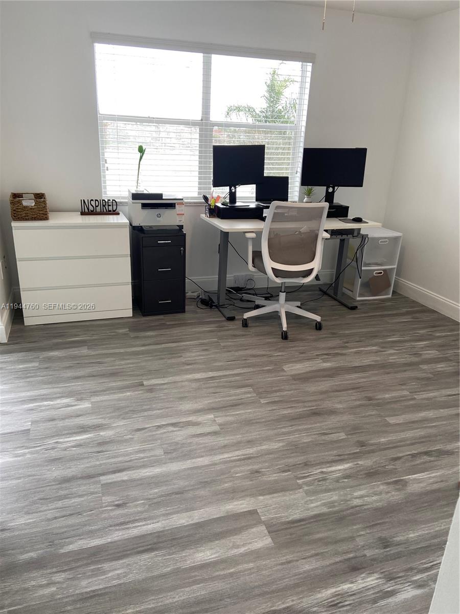 8640 Southwest 212th Street, Unit 304 Cutler Bay, FL 33189 - Photo 9 of 26 a view of a workspace with furniture and a window
