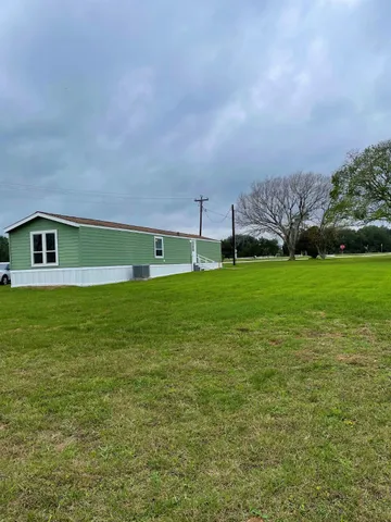 a backyard of a house with lots of green space