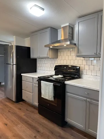 a kitchen with a stove a refrigerator and a sink