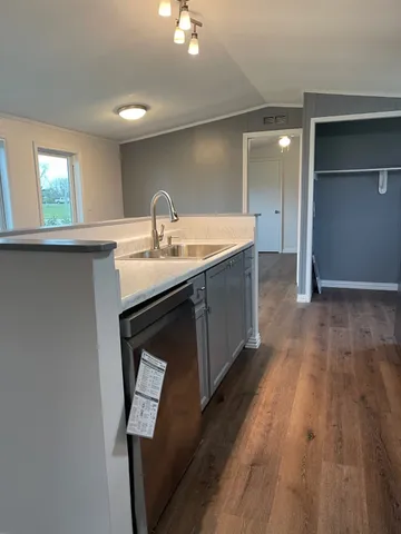 a kitchen with a sink a mirror and window