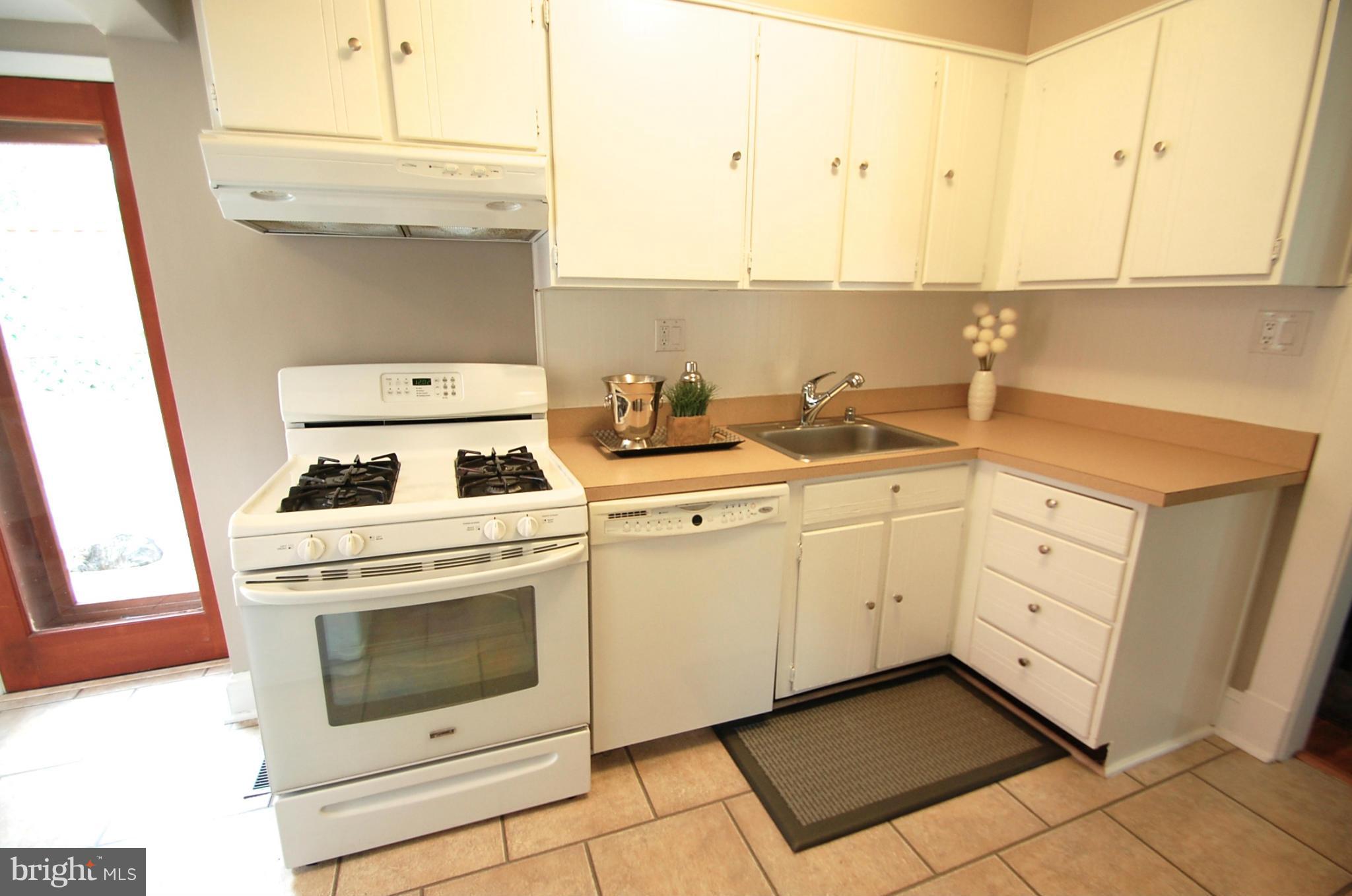 2104 Hanover Street Silver Spring, MD 20910 - Photo 8 of 22 a kitchen with white cabinets and white appliances