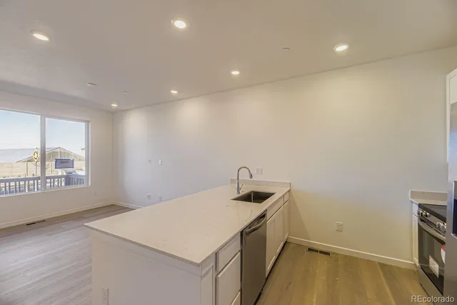 a view of storage and utility room with wooden floor