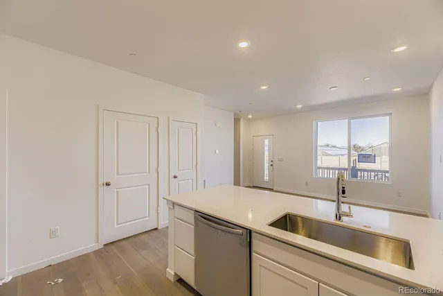 a view of kitchen with wooden floor and electronic appliances