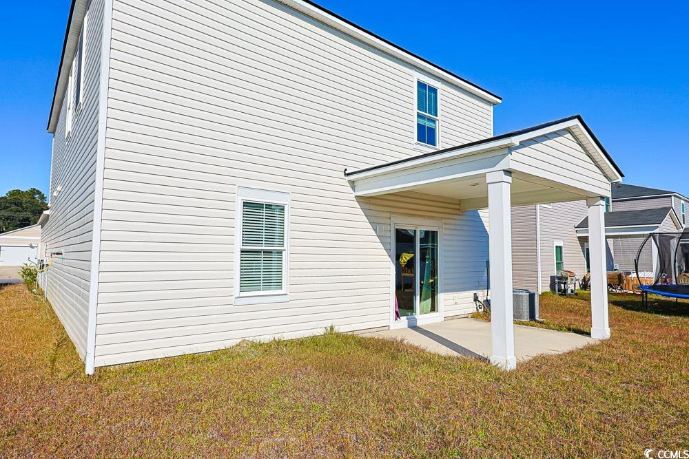 1560 Swing Bridge Way Myrtle Beach, SC 29588 - Photo 30 of 35 Back of house featuring a trampoline, a patio, and a yard