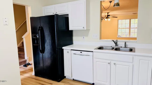 a kitchen with a refrigerator and a sink