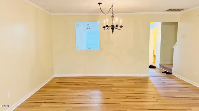 a view of a room with wooden floor and staircase