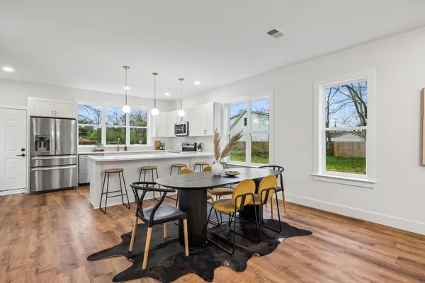 a view of a dining room with furniture and wooden floor