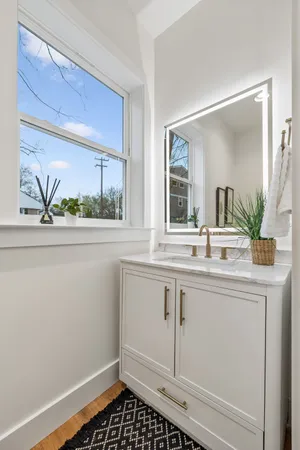a spacious bedroom with a bed a table and a window