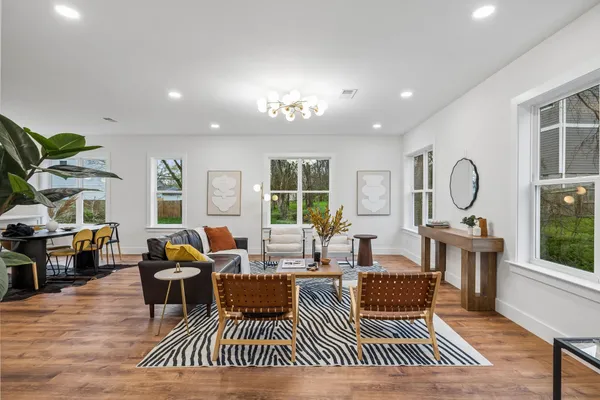 a living room with furniture a window and a chandelier