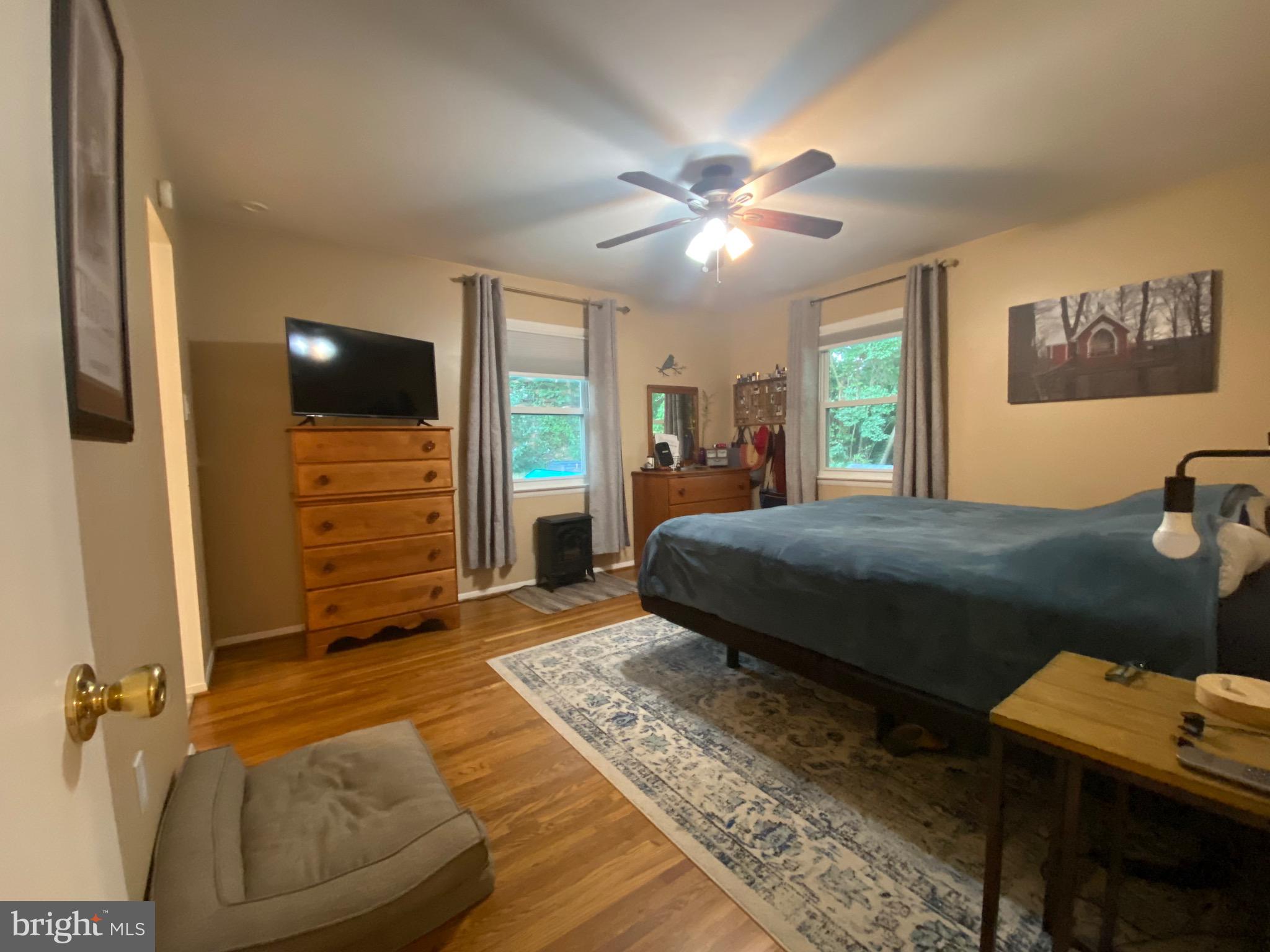 8614 Arley Drive Springfield, VA 22152 - Photo 11 of 24 a bedroom with a bed and a chandelier