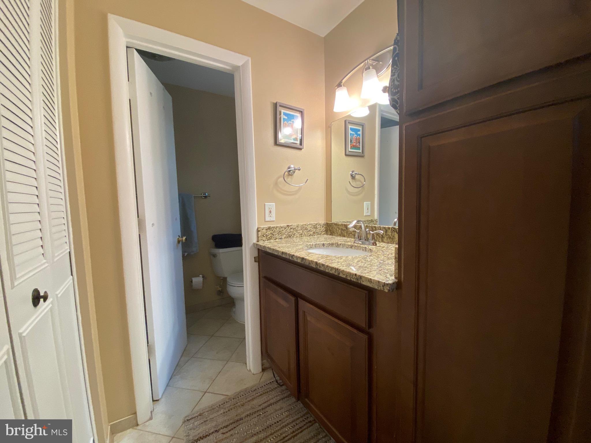 8614 Arley Drive Springfield, VA 22152 - Photo 12 of 24 a bathroom with a granite countertop sink and a mirror