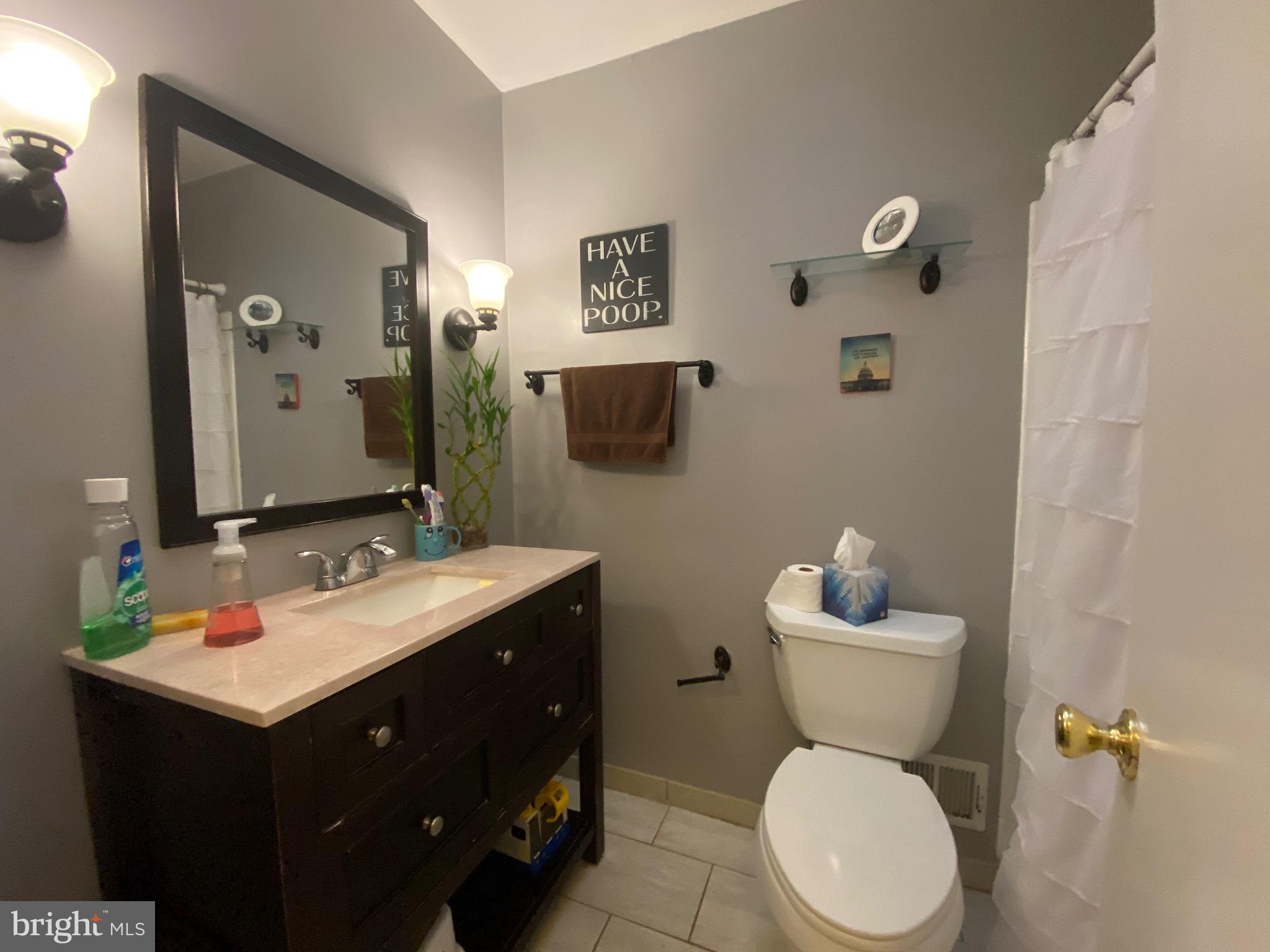 8614 Arley Drive Springfield, VA 22152 - Photo 13 of 24 a bathroom with a toilet sink and mirror