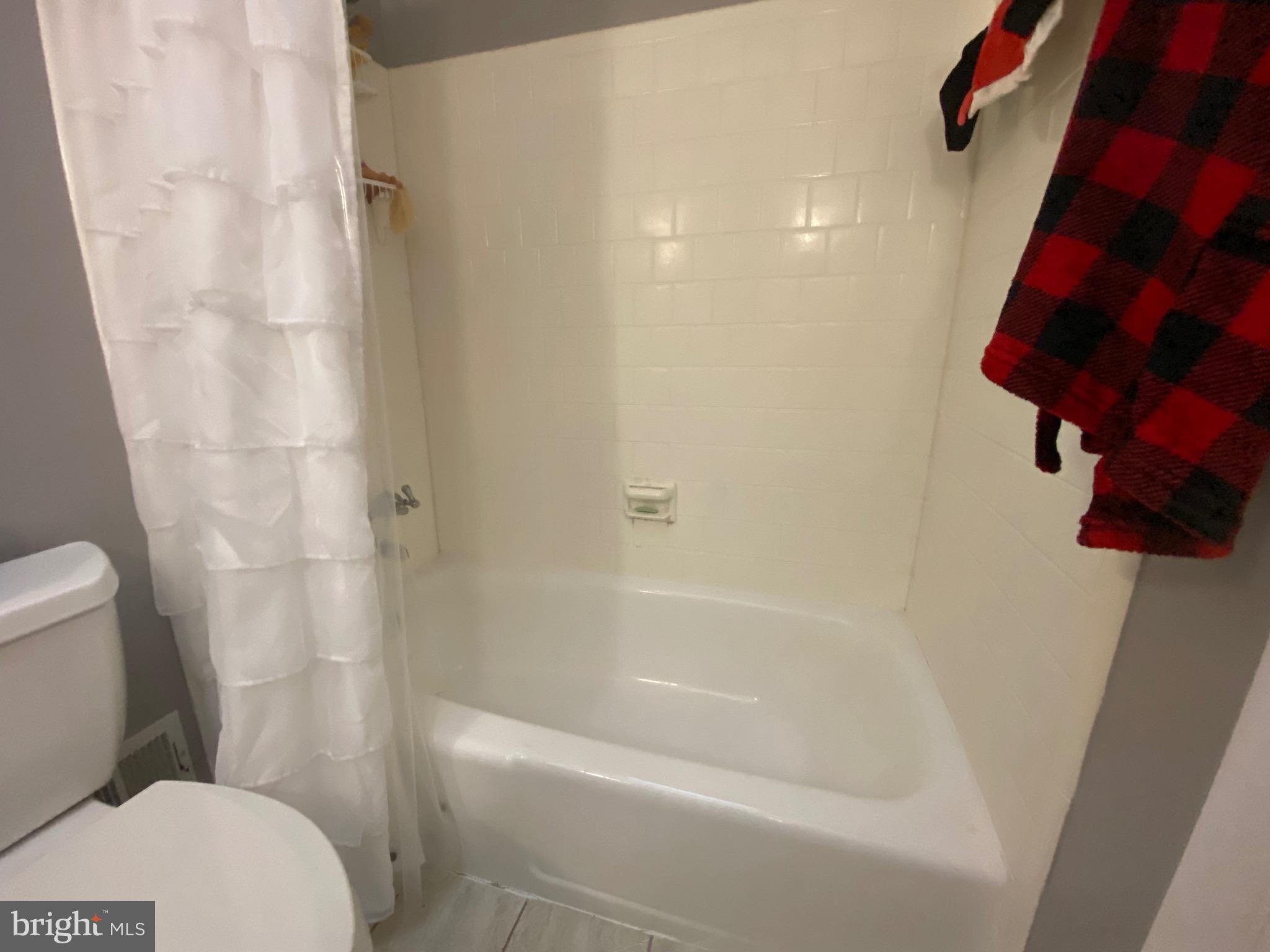 8614 Arley Drive Springfield, VA 22152 - Photo 14 of 24 a white bath tub sitting next to a white toilet and sink