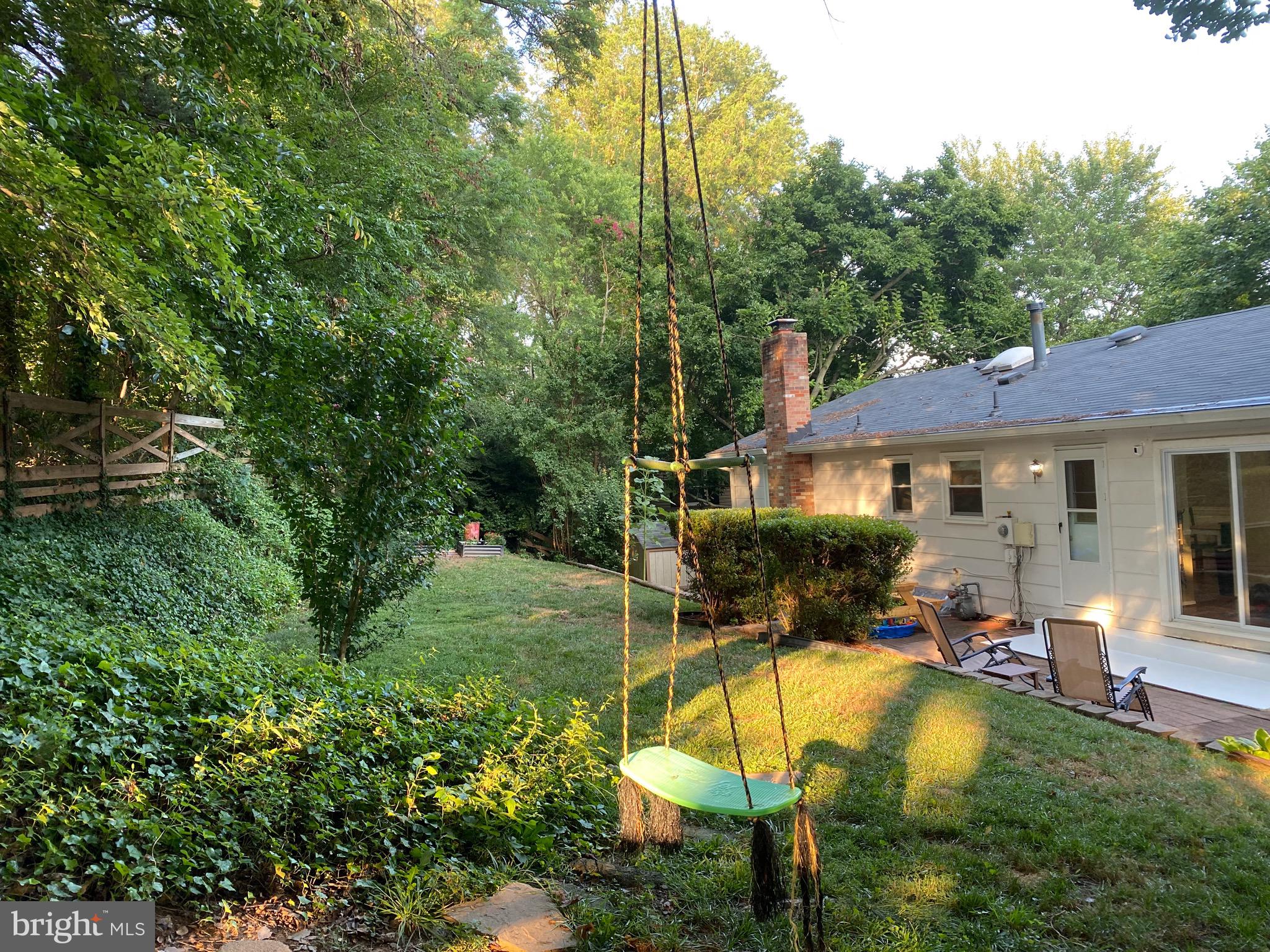 8614 Arley Drive Springfield, VA 22152 - Photo 17 of 24 a view of a patio with table and chairs under an umbrella