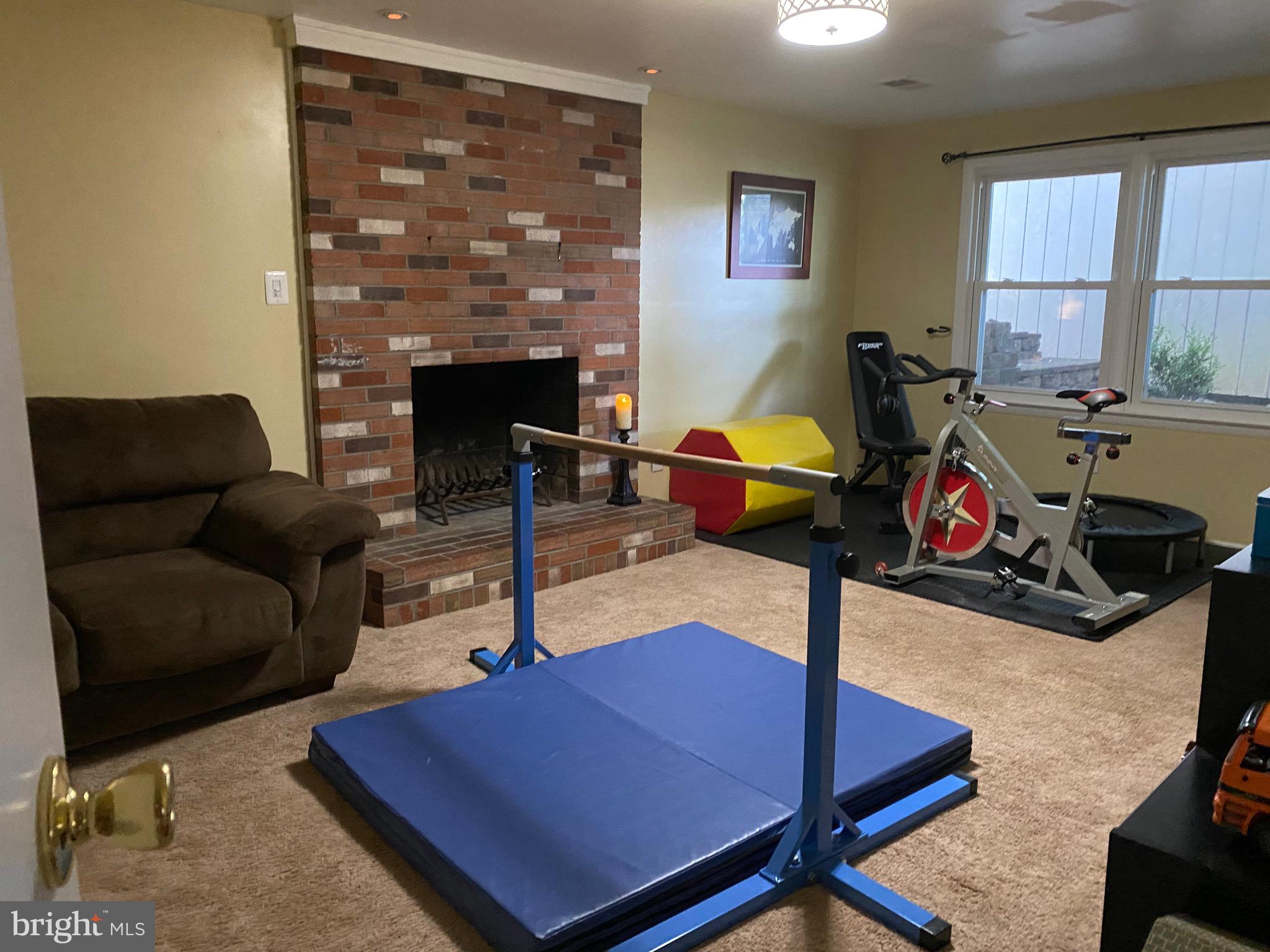 8614 Arley Drive Springfield, VA 22152 - Photo 19 of 24 a living room with furniture a rug and a fireplace