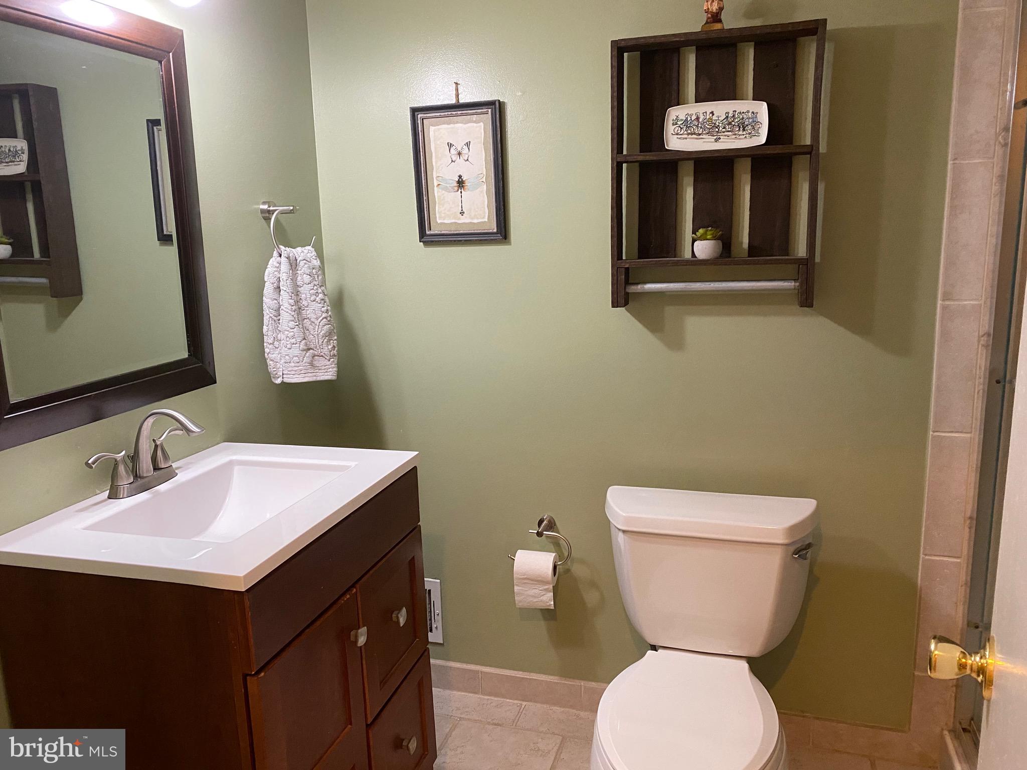 8614 Arley Drive Springfield, VA 22152 - Photo 23 of 24 a bathroom with a toilet sink and mirror
