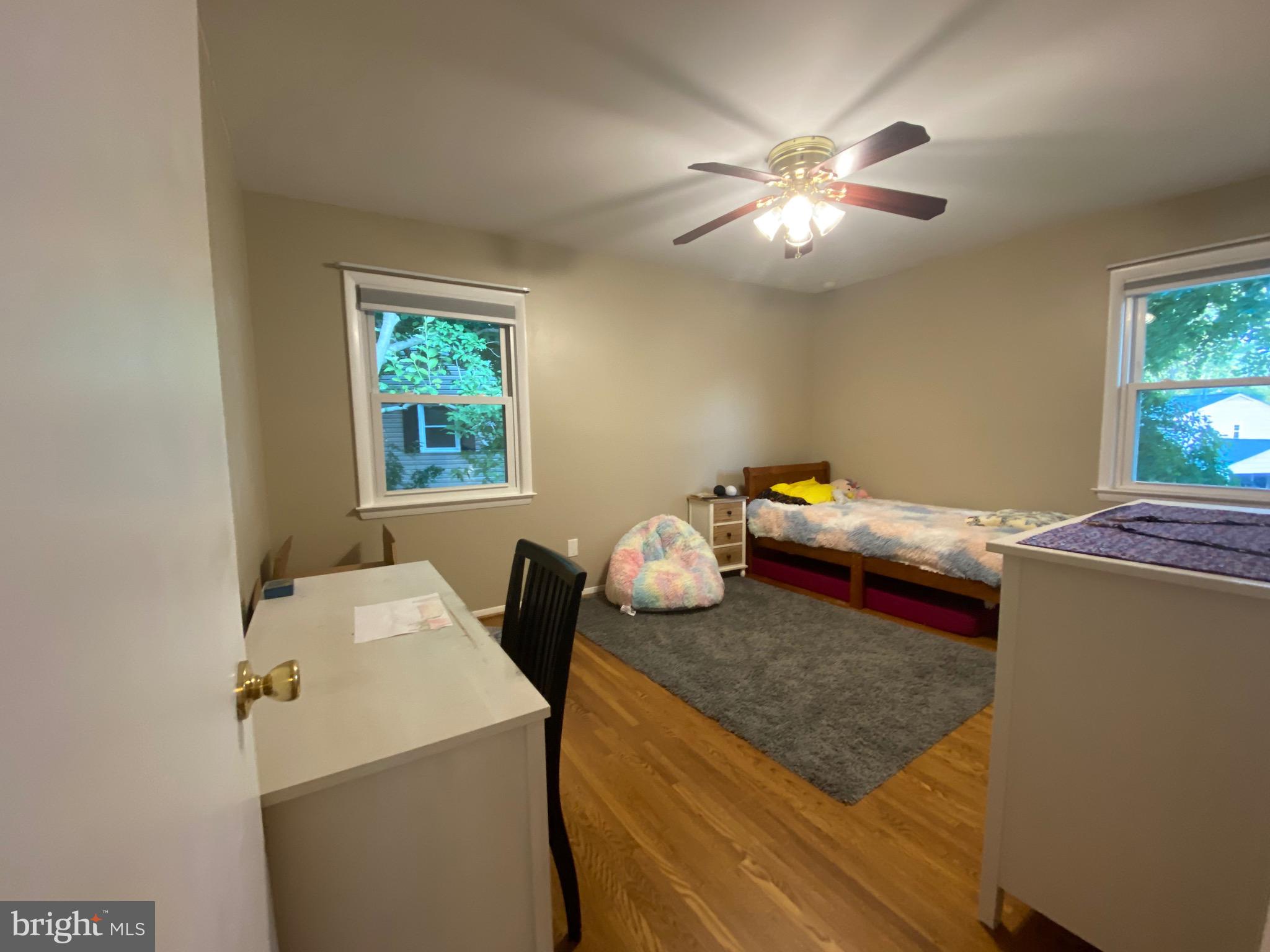 8614 Arley Drive Springfield, VA 22152 - Photo 9 of 24 a bedroom with a bed and a chandelier