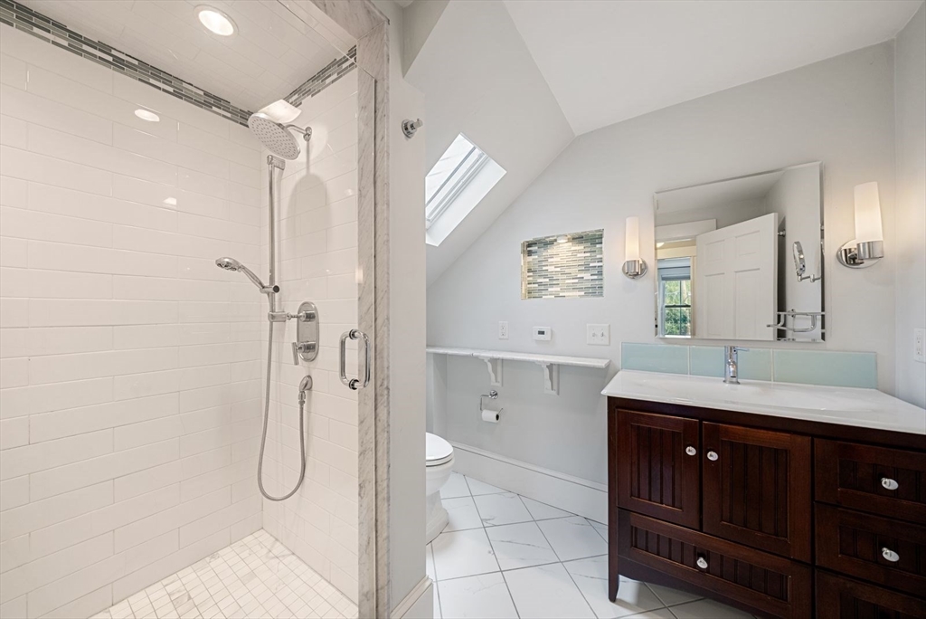 48 Golden Ball Road Weston, MA 02493 - Photo 18 of 21 a bathroom with a double vanity sink a mirror a glass door a shower and vanity