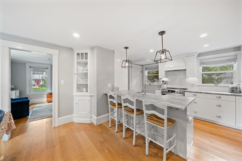 48 Golden Ball Road Weston, MA 02493 - Photo 7 of 21 a view of a kitchen with kitchen island and stainless steel appliances