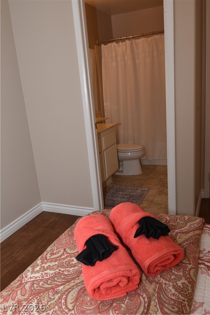 267 Westwind Road Henderson, NV 89074 - Photo 14 of 16 A well-appointed bathroom offers privacy and convenience, with clean tiling underfoot.