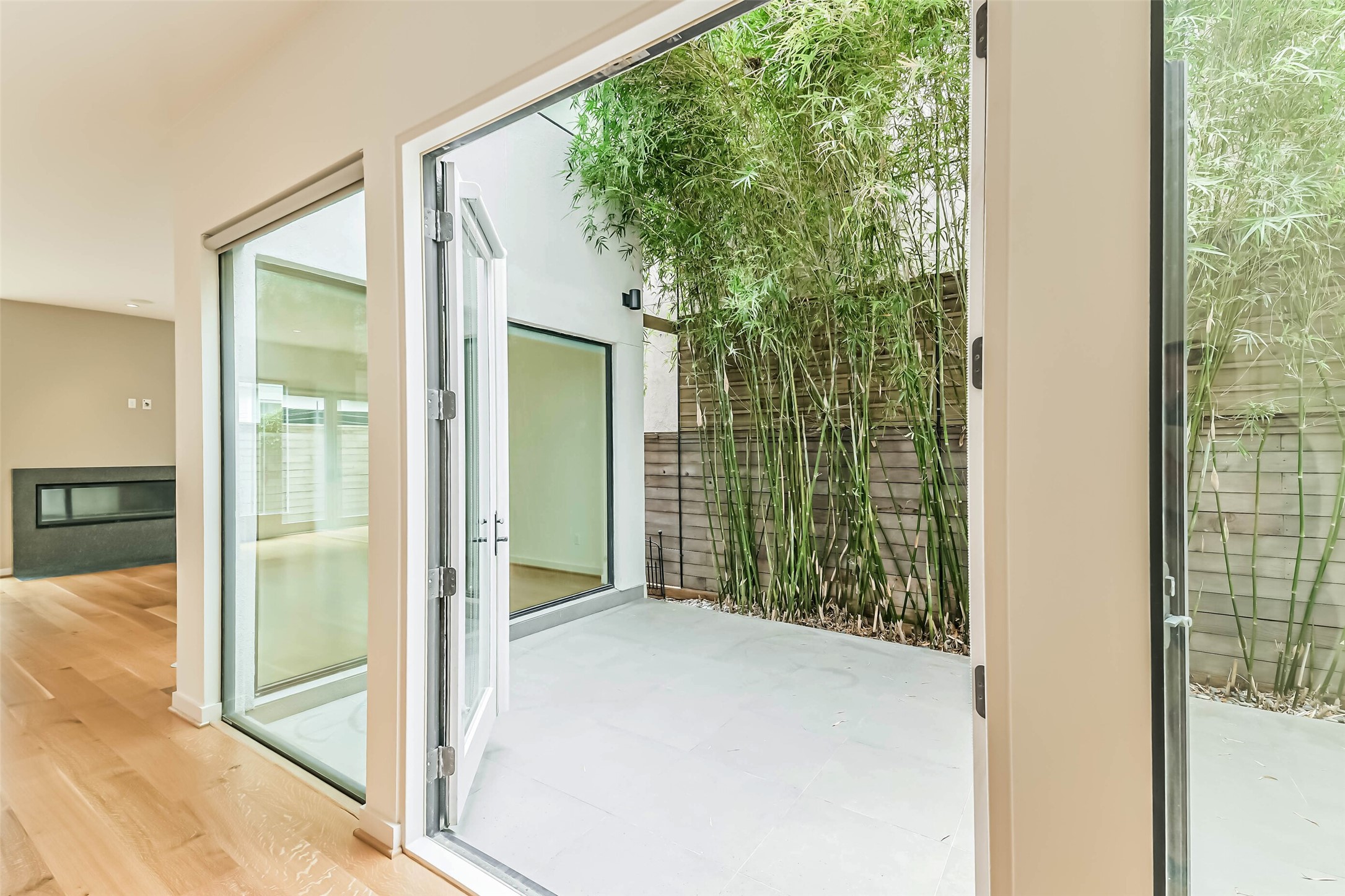 815 Alexander Street Houston, TX 77007 - Photo 8 of 49 Private outdoor atrium with glass doors creating seamless indoor-outdoor living.