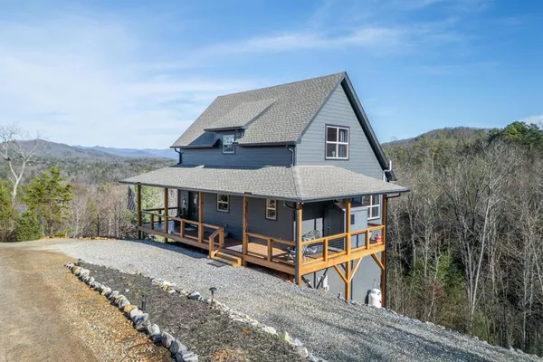 a view of a house with a yard and roof