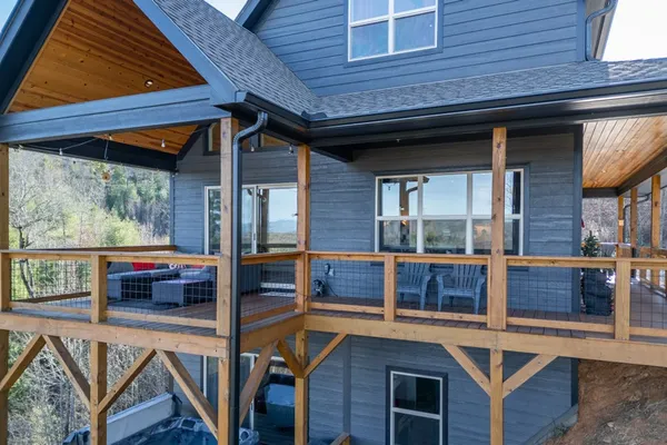 a view of backyard with a large tree and deck